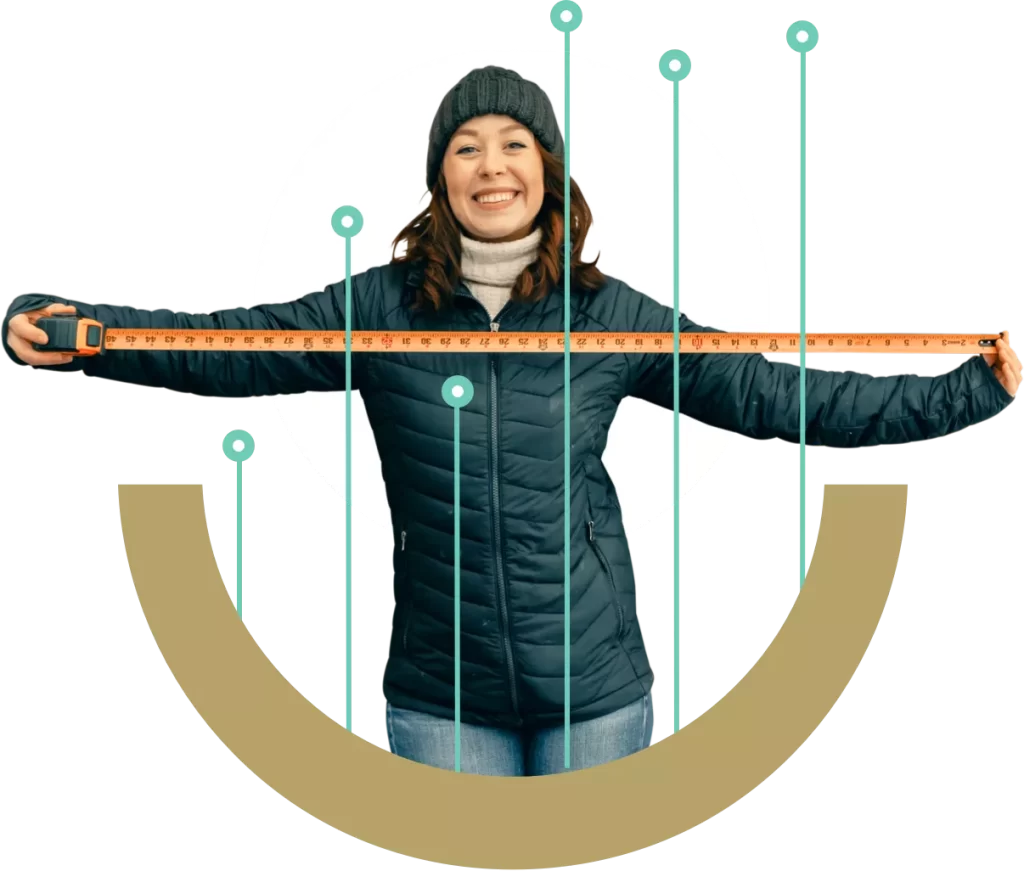 Smiling Woman in Winter Clothes Holding A Measuring Tape