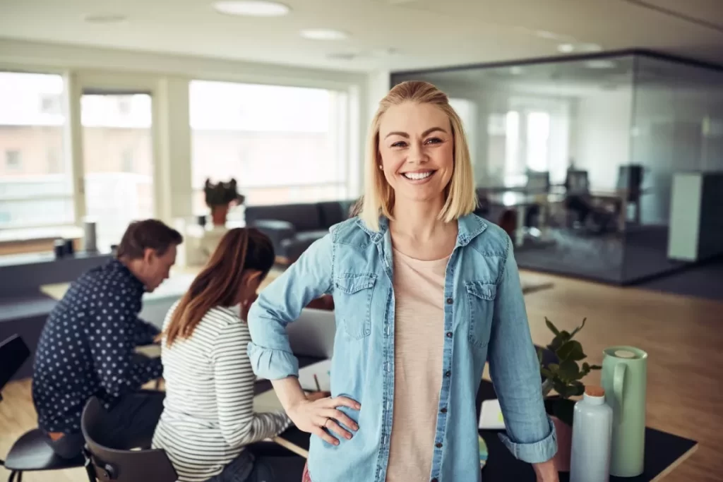 Smiling Woman in Denim Jacket in the Office