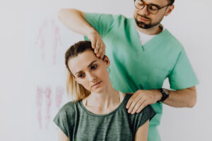 A male chiropractor treating a female patient.