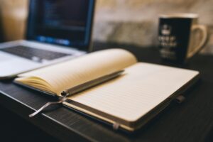 Work Table With Laptop, Notes And Coffee Mug